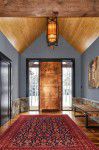 interior-design-aspen - A Foyer with a custom copper entry door with a hand blown glass chandelier and exterior stone half wall in Aspen Valley designed by Runa Novak of In Your Space Interior Design - InYourSpaceHome.com and RunaNovak.com