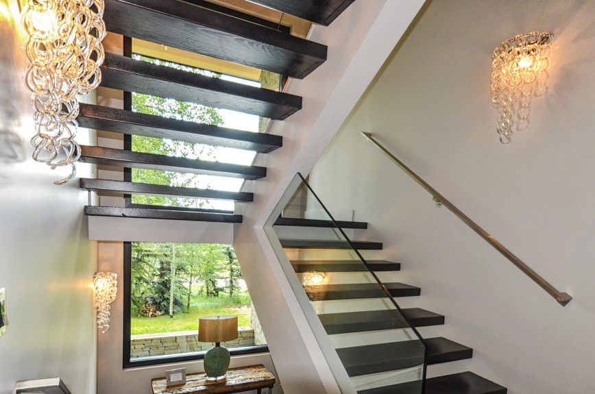 interior-design-firm-chicago - Floating staircase with metal hand rail and glass railing designed by Runa Novak of In Your Space Interior Design - InYourSpaceHome.com and RunaNovak.com