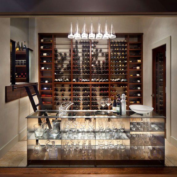 A modern wine room with a storefront window designed by Runa Novak of In Your Space Interior Design www.iysinteriordesign.com