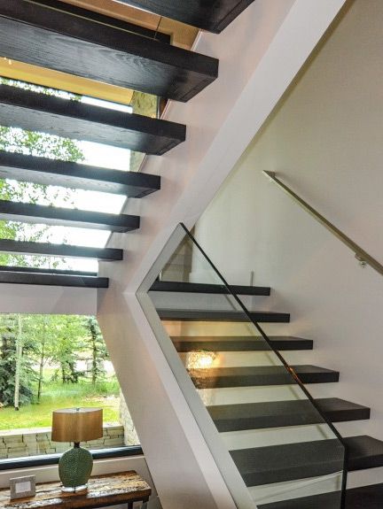 custom-staircase - After Photo of Aspen house Floating staircase with metal hand rail and glass railing designed by Runa Novak of In Your Space Interior Design - InYourSpaceHome.com and RunaNovak.com